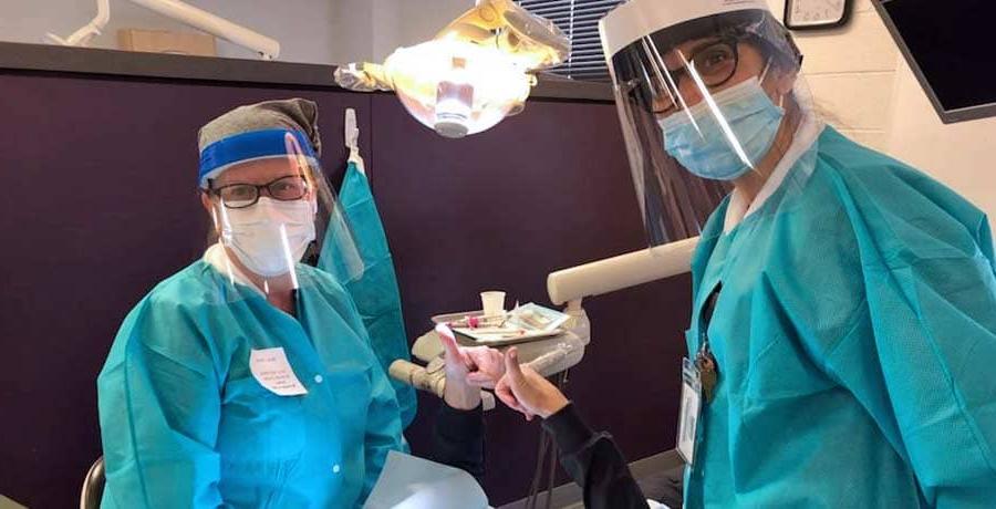 A UB Dental Hygiene student working on a patient